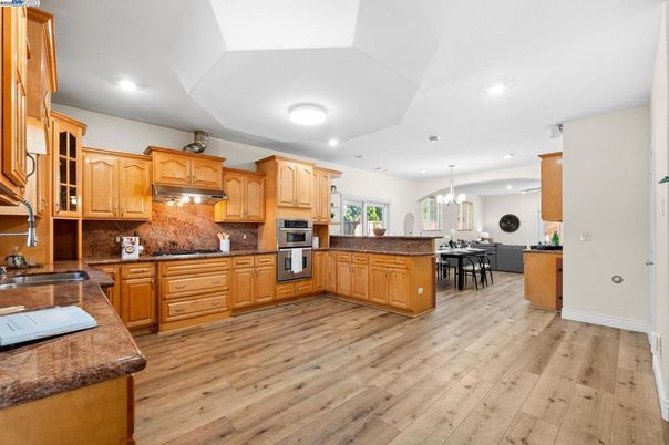 Dining room, Interior, Kitchen, Pendant Lights, Recessed Lighting, Stainless Steel Appliances, Wood Texture Flooring