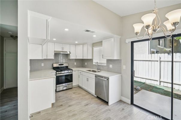Chandelier, Interior, Kitchen, Pendant Lights, Recessed Lighting, Stainless Steel Appliances, Wood Texture Flooring