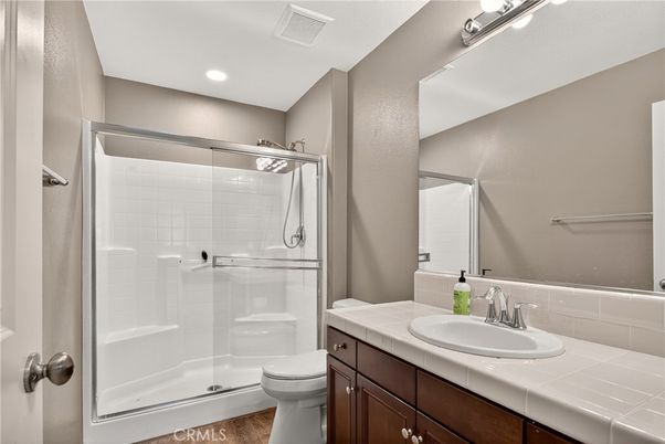 Bathroom, Glass Shower, Interior, Recessed Lighting, Tile Countertops, Wood Texture Flooring