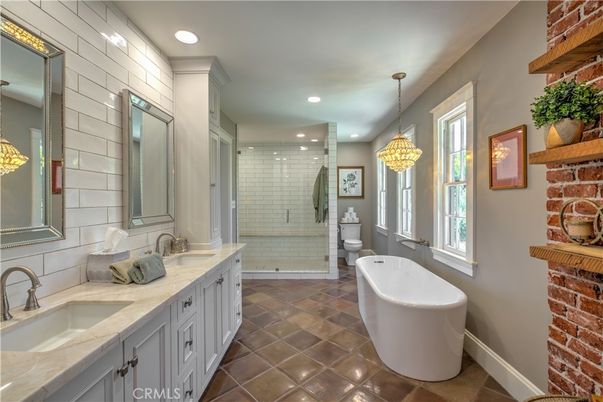 Bathroom, Chandelier, Dual Sink Vanities, Free Standing Baths, Glass Shower, Interior, Pendant Lights, Recessed Lighting, Stone Walls