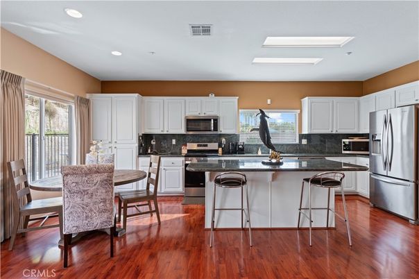 Dining room, Interior, Kitchen, Recessed Lighting, Stainless Steel Appliances, Wood Texture Flooring