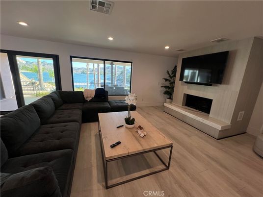 Fireplace, Interior, Living room, Recessed Lighting, Water, Wood Texture Flooring
