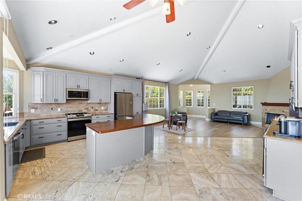 Dining room, Fireplace, Interior, Kitchen, Living room, Recessed Lighting, Stainless Steel Appliances, Wood Texture Flooring