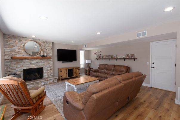 Fireplace, Interior, Living room, Recessed Lighting, Stone Walls, Wood Texture Flooring