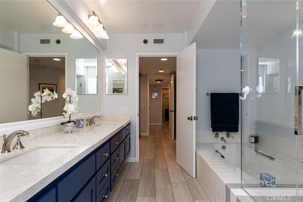 Bathroom, Dual Sink Vanities, Glass Shower, Interior, Recessed Lighting, Wood Texture Flooring