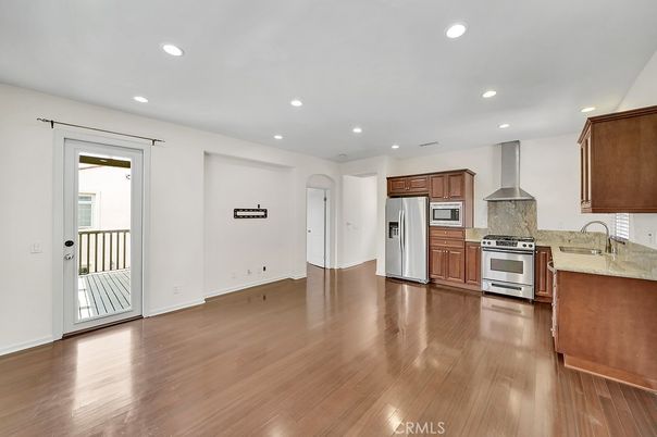 Empty room, Interior, Kitchen, Recessed Lighting, Stainless Steel Appliances, Wood Texture Flooring