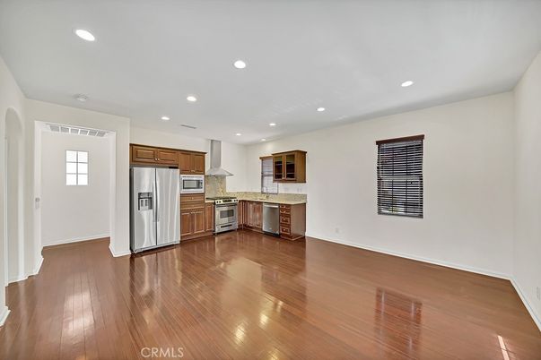 Empty room, Interior, Kitchen, Recessed Lighting, Stainless Steel Appliances, Wood Texture Flooring