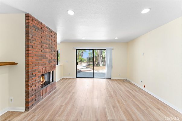 Empty room, Fireplace, Interior, Recessed Lighting, Stone Walls, Wood Texture Flooring