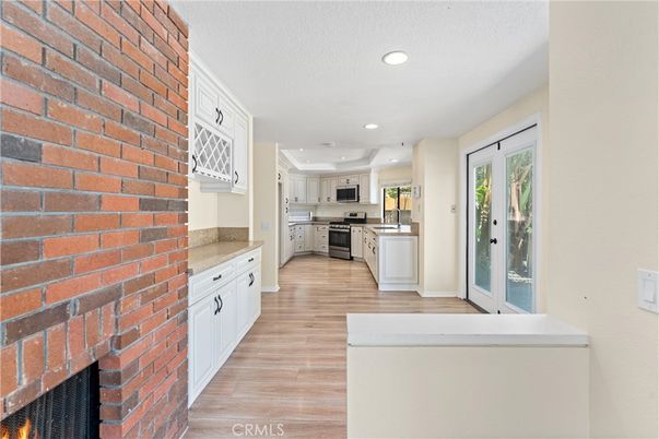 Fireplace, Interior, Kitchen, Recessed Lighting, Stainless Steel Appliances, Stone Walls, Wood Texture Flooring