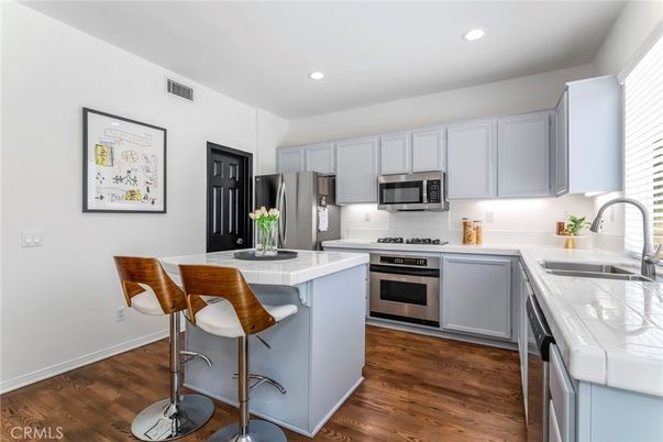 Interior, Kitchen, Recessed Lighting, Stainless Steel Appliances, Tile Countertops, Wood Texture Flooring