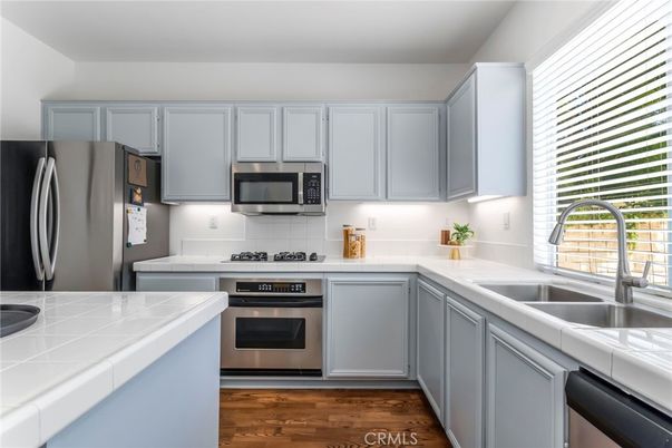 Interior, Kitchen, Stainless Steel Appliances, Tile Countertops, Wood Texture Flooring