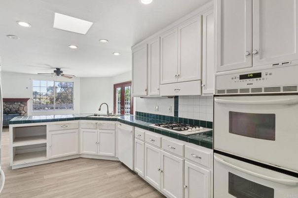 Interior, Kitchen, Recessed Lighting, Tile Countertops, Wood Texture Flooring
