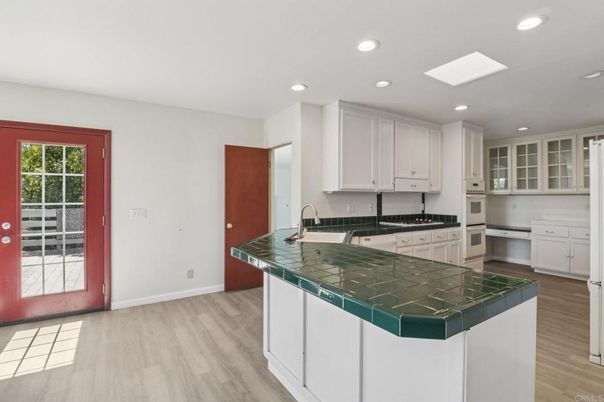 Interior, Kitchen, Recessed Lighting, Tile Countertops, Wood Texture Flooring