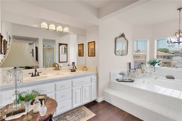 Bathroom, Chandelier, Dual Sink Vanities, Interior, Tile Countertops, Wood Texture Flooring