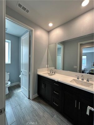 Bathroom, Dual Sink Vanities, Interior, Recessed Lighting, Wood Texture Flooring