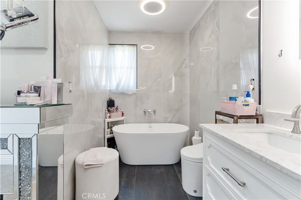 Bathroom, Dual Sink Vanities, Free Standing Baths, Interior, Marble Walls, Recessed Lighting, Wood Texture Flooring