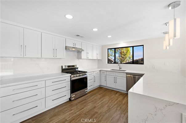 Interior, Kitchen, Marble Walls, Pendant Lights, Recessed Lighting, Stainless Steel Appliances, Wood Texture Flooring