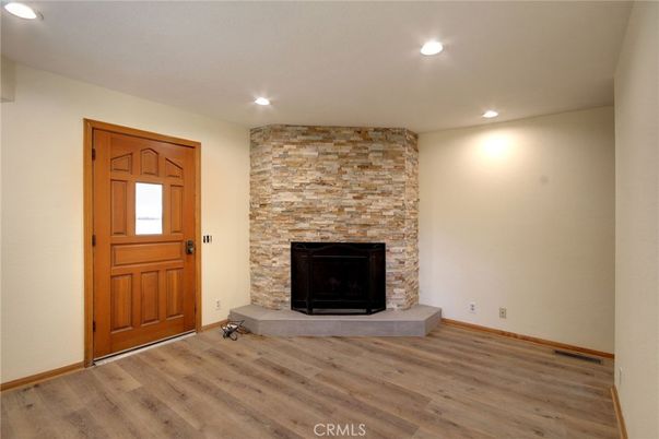 Empty room, Fireplace, Interior, Recessed Lighting, Stone Walls, Wood Texture Flooring