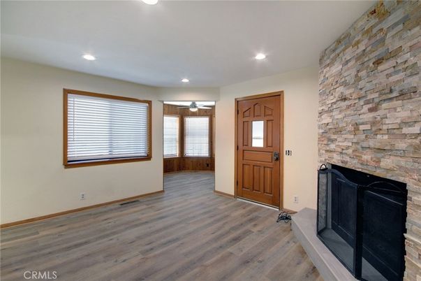 Empty room, Fireplace, Interior, Recessed Lighting, Stone Walls, Wood Texture Flooring