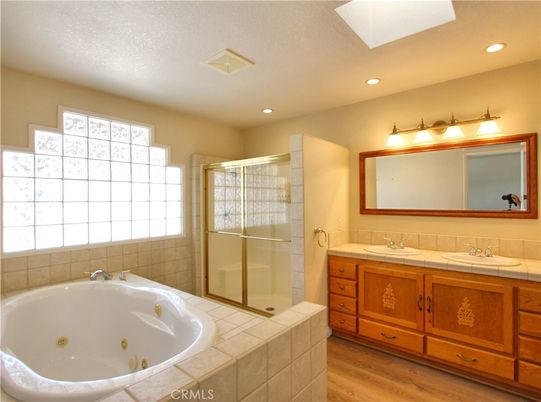 Bathroom, Dual Sink Vanities, Glass Shower, Interior, Recessed Lighting, Tile Countertops, Wood Texture Flooring