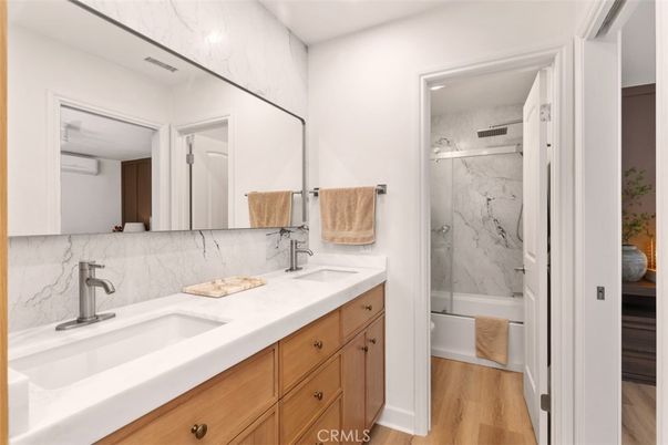 Bathroom, Dual Sink Vanities, Glass Shower, Interior, Marble Walls, Wood Texture Flooring