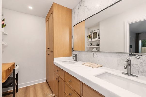 Bathroom, Dual Sink Vanities, Interior, Marble Walls, Recessed Lighting, Wood Texture Flooring