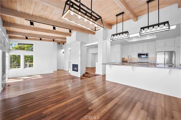 Empty room, Fireplace, Interior, Kitchen, Pendant Lights, Stainless Steel Appliances, Wooden Beams, Wooden Ceilings, Wood Texture Flooring