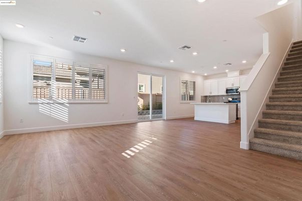 Empty room, Interior, Kitchen, Recessed Lighting, Stainless Steel Appliances, Wood Texture Flooring