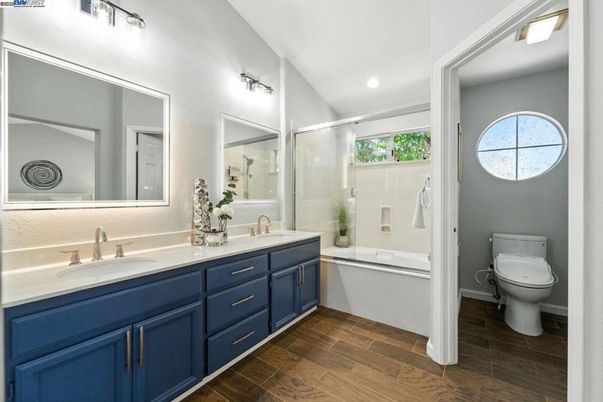 Bathroom, Dual Sink Vanities, Glass Shower, Interior, Recessed Lighting, Wood Texture Flooring