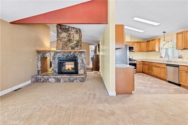 Fireplace, Interior, Kitchen, Pendant Lights, Stainless Steel Appliances, Stone Walls