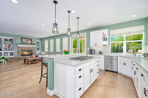 Fireplace, Interior, Kitchen, Living room, Pendant Lights, Recessed Lighting, Stainless Steel Appliances, Wood Texture Flooring