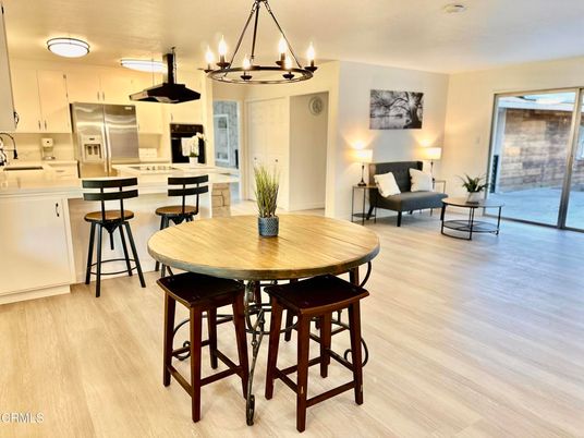 Chandelier, Dining room, Interior, Kitchen, Living room, Pendant Lights, Stainless Steel Appliances, Wood Texture Flooring