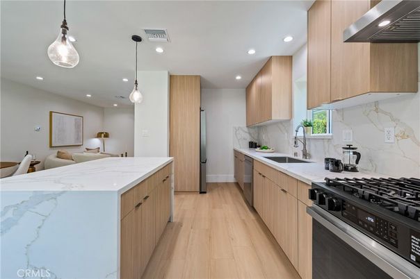 Interior, Kitchen, Marble Walls, Pendant Lights, Recessed Lighting, Stainless Steel Appliances, Wood Texture Flooring