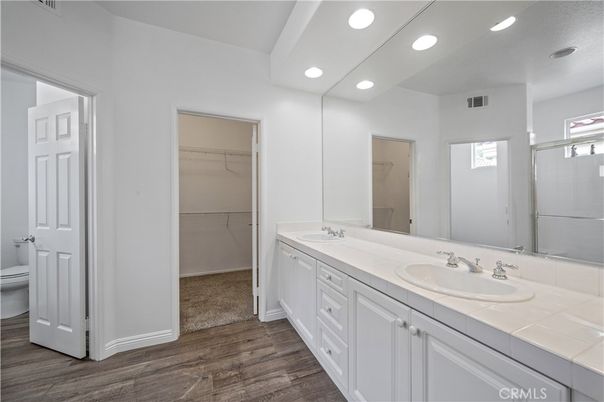 Bathroom, Dual Sink Vanities, Interior, Recessed Lighting, Tile Countertops, Walk-in Closets, Wood Texture Flooring
