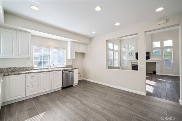 Fireplace, Interior, Kitchen, Recessed Lighting, Stainless Steel Appliances, Wood Texture Flooring