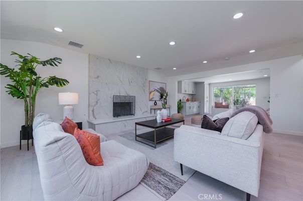 Fireplace, Interior, Living room, Marble Walls, Recessed Lighting, Wood Texture Flooring