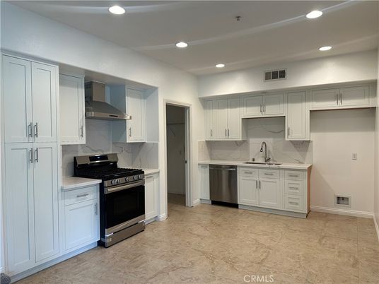 Interior, Kitchen, Marble Walls, Recessed Lighting, Stainless Steel Appliances
