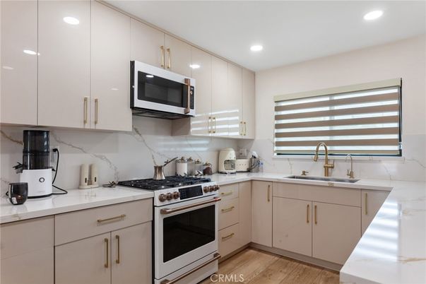 Interior, Kitchen, Marble Walls, Recessed Lighting, Stainless Steel Appliances, Wood Texture Flooring