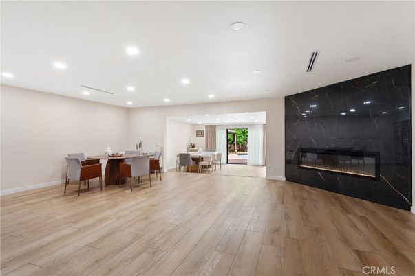 Dining room, Fireplace, Interior, Marble Walls, Recessed Lighting, Wood Texture Flooring