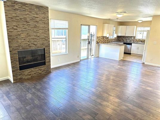 Empty room, Fireplace, Interior, Kitchen, Pendant Lights, Stone Walls, Wood Texture Flooring