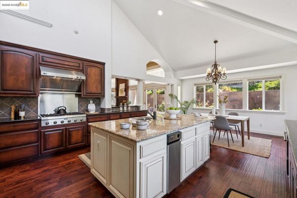 Chandelier, Dining room, Interior, Kitchen, Recessed Lighting, Stainless Steel Appliances, Wood Texture Flooring