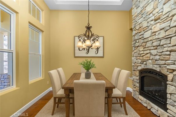 Chandelier, Dining room, Fireplace, Interior, Stone Walls, Wood Texture Flooring