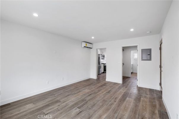 Empty room, Interior, Kitchen, Recessed Lighting, Stainless Steel Appliances, Wood Texture Flooring