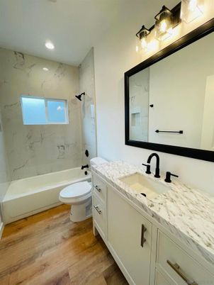 Bathroom, Dual Sink Vanities, Interior, Marble Walls, Recessed Lighting, Wood Texture Flooring