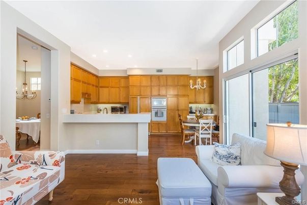 Chandelier, Dining room, Interior, Kitchen, Living room, Pendant Lights, Recessed Lighting, Stainless Steel Appliances, Wood Texture Flooring