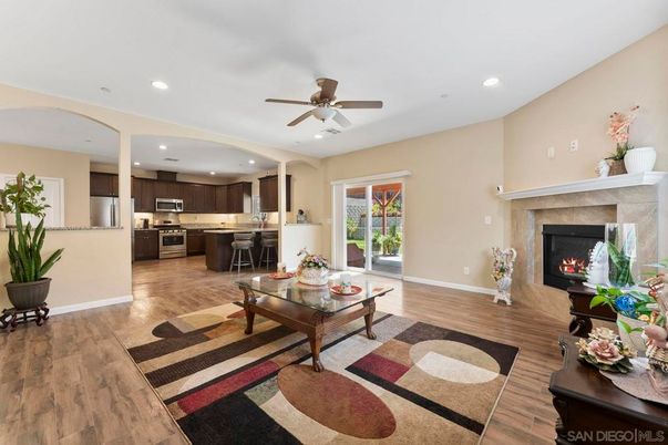 Dining room, Fireplace, Interior, Kitchen, Living room, Recessed Lighting, Stainless Steel Appliances, Wood Texture Flooring