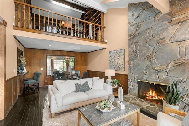 Dining room, Fireplace, Interior, Living room, Recessed Lighting, Stone Walls, Wood Texture Flooring