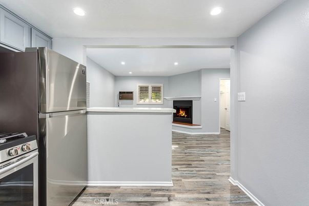 Fireplace, Interior, Kitchen, Recessed Lighting, Stainless Steel Appliances, Wood Texture Flooring