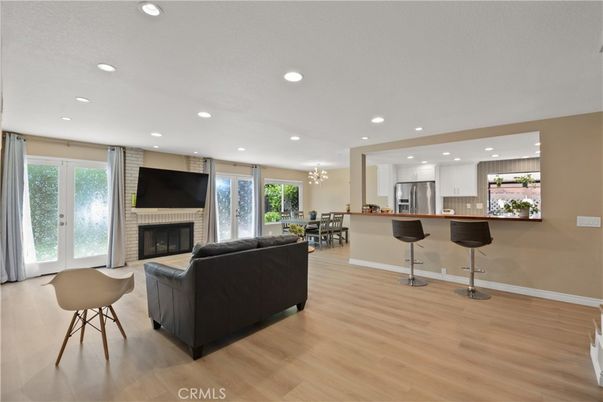 Chandelier, Dining room, Fireplace, Interior, Kitchen, Living room, Recessed Lighting, Stainless Steel Appliances, Wood Texture Flooring