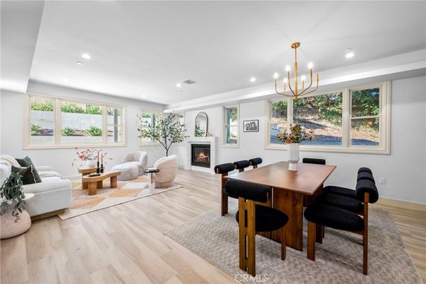 Chandelier, Dining room, Fireplace, Interior, Living room, Pendant Lights, Recessed Lighting, Wood Texture Flooring